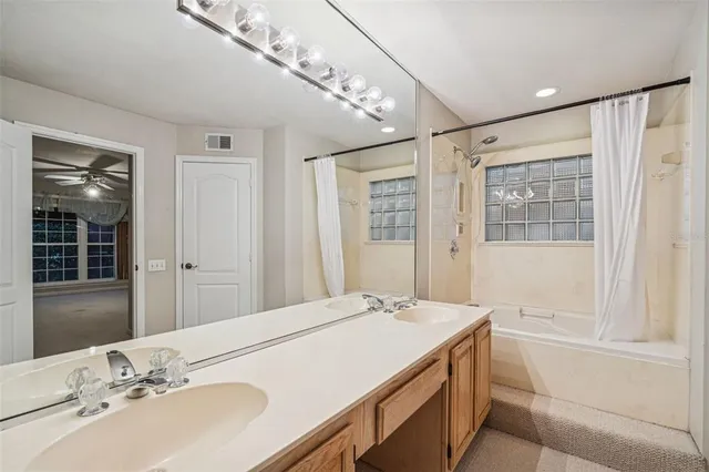a bathroom with a double vanity sink and a mirror