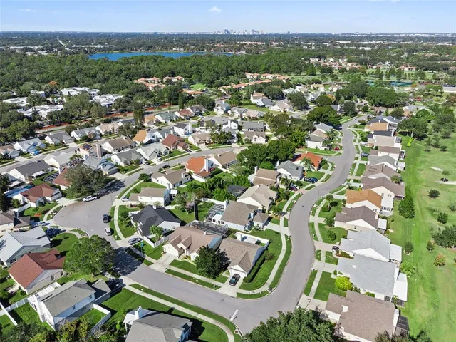 an aerial view of residential houses with outdoor space and parking