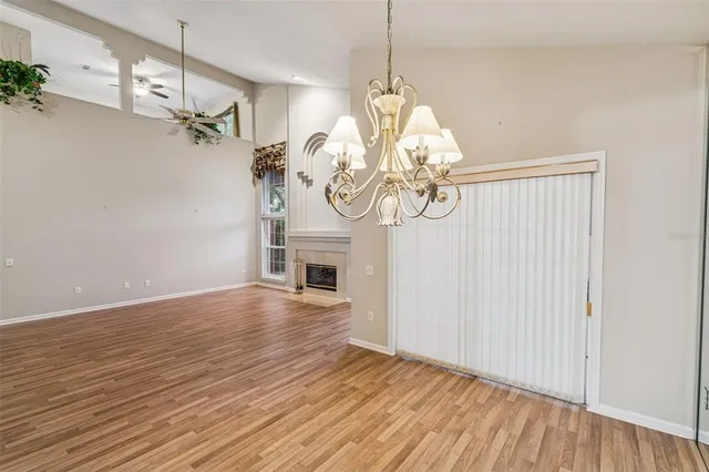 a view of a room with wooden floor and chandelier