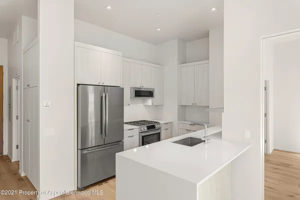 a kitchen with a refrigerator sink and stove