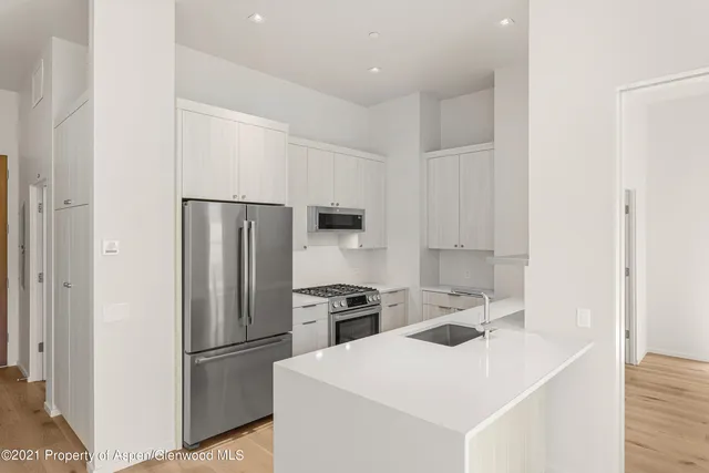 a kitchen with a refrigerator sink and stove