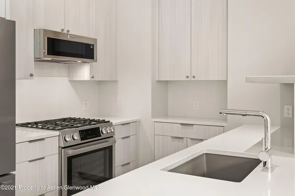 a kitchen with a sink and a stove top oven