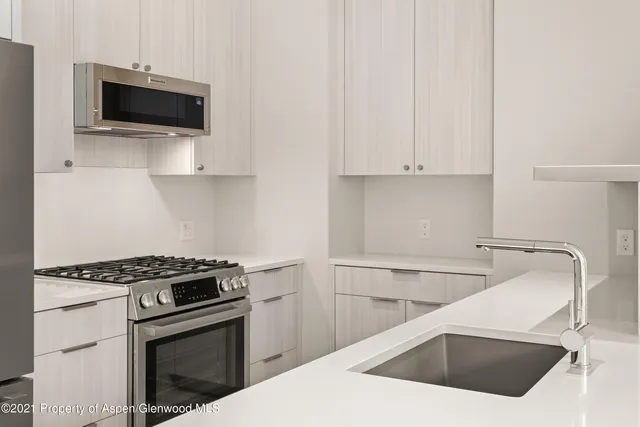 a kitchen with a sink and a stove top oven