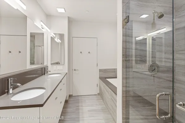 a bathroom with a granite countertop sink mirror and shower