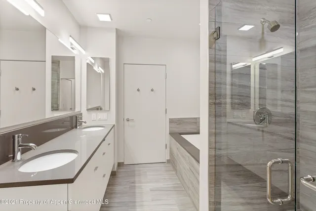 a bathroom with a granite countertop sink mirror and shower