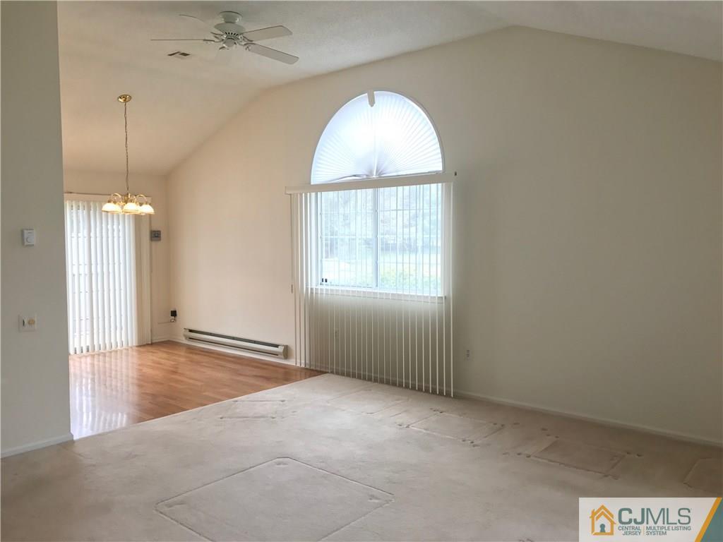 838 C Vail Road Monroe Township, NJ 08831 - Photo 2 of 20 an empty room with chandelier fan and windows