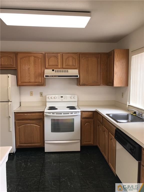 838 C Vail Road Monroe Township, NJ 08831 - Photo 5 of 20 a kitchen with stainless steel appliances granite countertop a sink stove and refrigerator