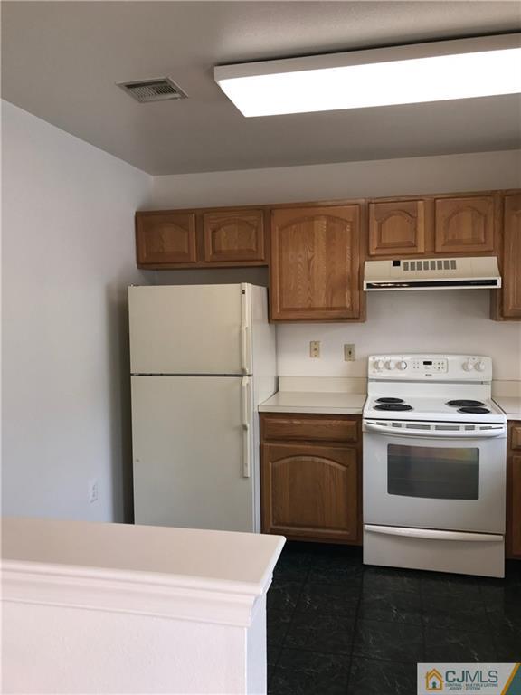 838 C Vail Road Monroe Township, NJ 08831 - Photo 6 of 20 a kitchen with a stove and a refrigerator