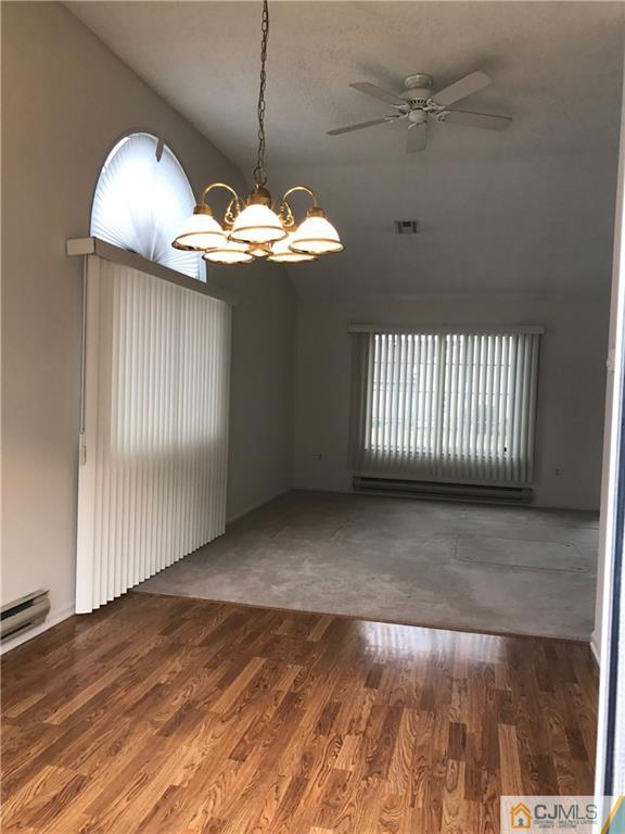 838 C Vail Road Monroe Township, NJ 08831 - Photo 8 of 20 an empty room with wooden floor and windows