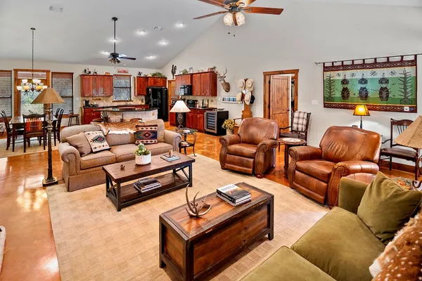 a kitchen with stainless steel appliances granite countertop a stove a sink dishwasher and white cabinets with wooden floor