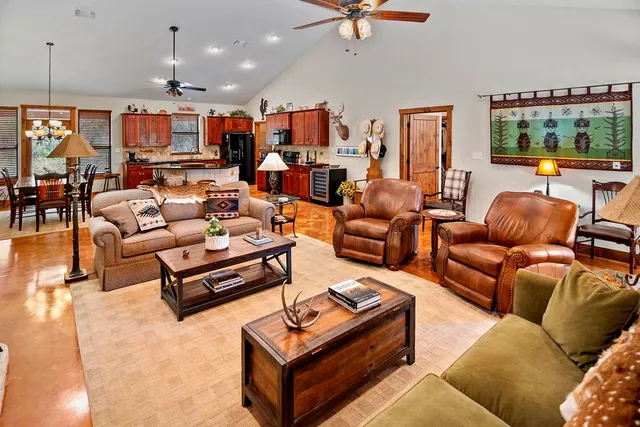 a kitchen with stainless steel appliances granite countertop a stove a sink dishwasher and white cabinets with wooden floor