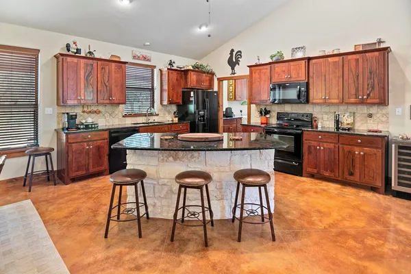 a view of dining room kitchen island stainless steel appliances a table and chairs
