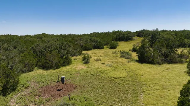 a view of a chair and fire pit in the middle of a yard