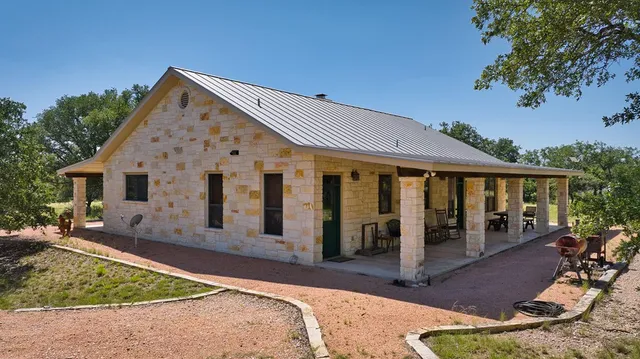 a view of a house with backyard porch and sitting area