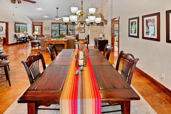 a living room with furniture a fireplace and a large window