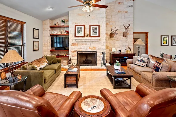 a living room with furniture kitchen view and a large window