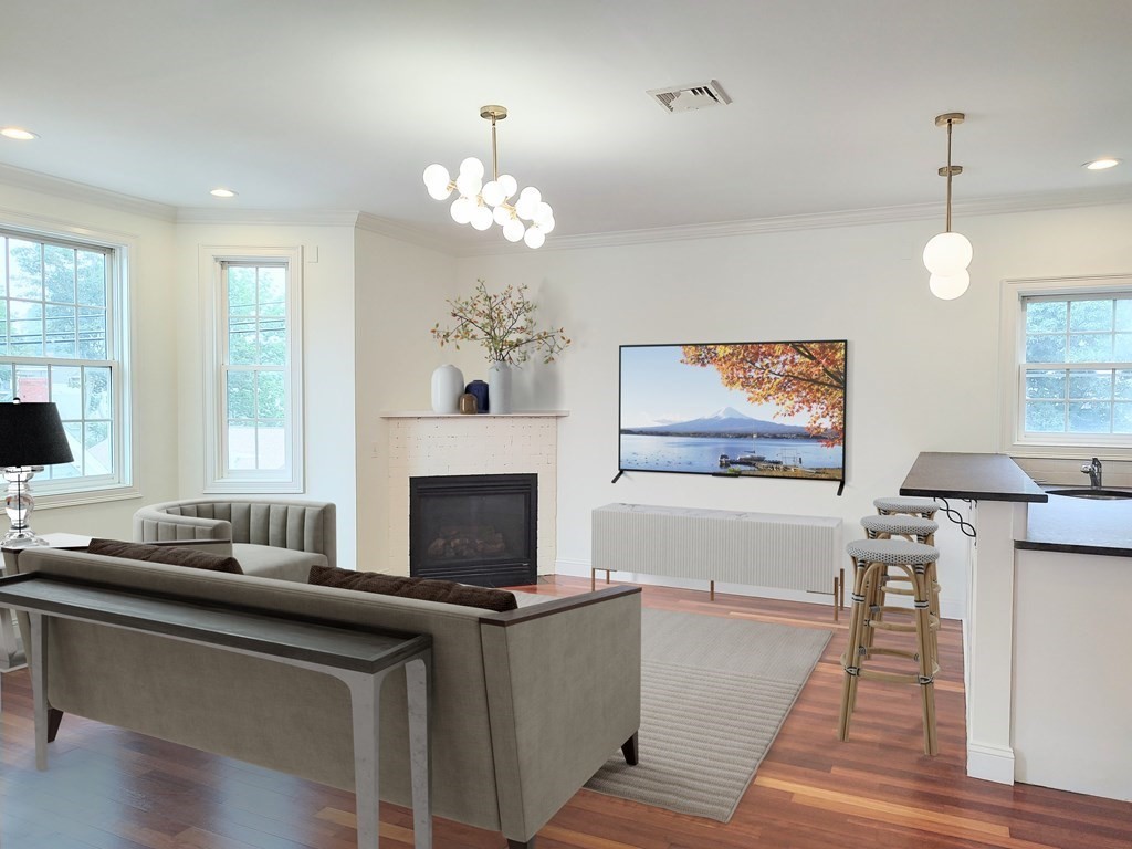 604 Freeport Street, Unit PH 5 Boston, MA 02122 - Photo 1 of 38 a living room with furniture a fireplace and a flat screen tv