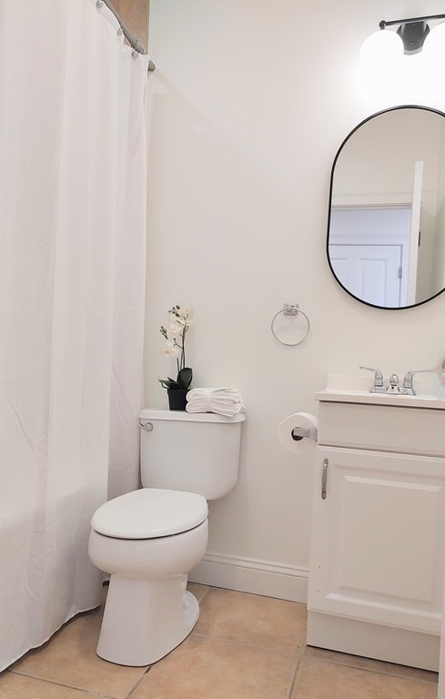 604 Freeport Street, Unit PH 5 Boston, MA 02122 - Photo 18 of 38 a bathroom with a toilet and a mirror
