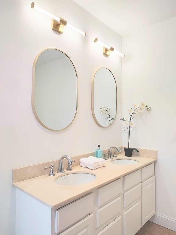 604 Freeport Street, Unit PH 5 Boston, MA 02122 - Photo 23 of 38 a bathroom with a granite countertop double vanity sinks and a mirror