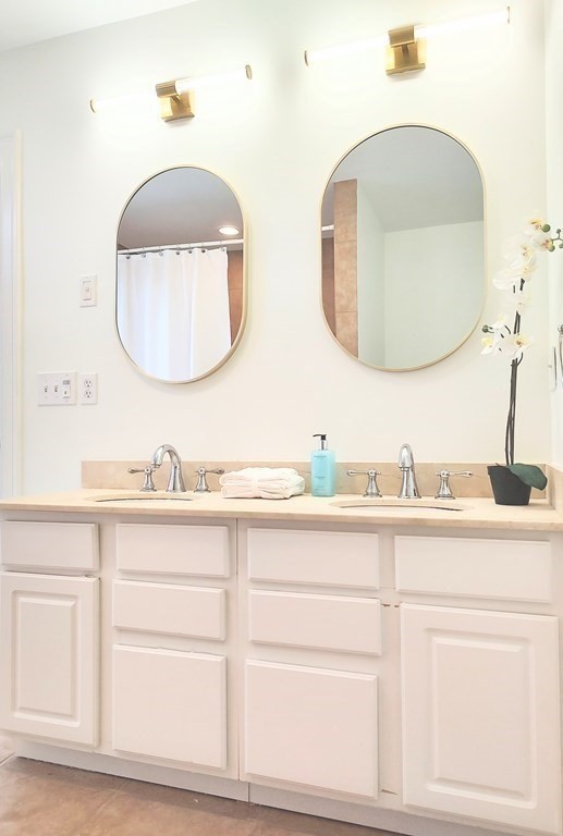 604 Freeport Street, Unit PH 5 Boston, MA 02122 - Photo 24 of 38 a bathroom with a double vanity sink and a mirror