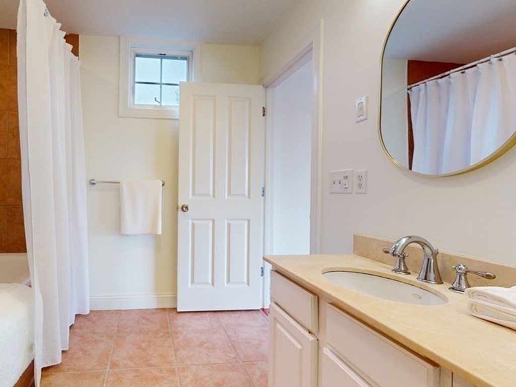 604 Freeport Street, Unit PH 5 Boston, MA 02122 - Photo 27 of 38 a bathroom with a sink vanity and a mirror