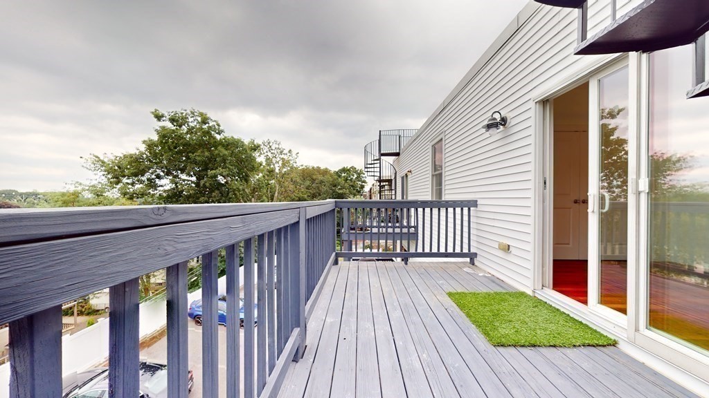604 Freeport Street, Unit PH 5 Boston, MA 02122 - Photo 34 of 38 a view of deck with wooden floor and fence