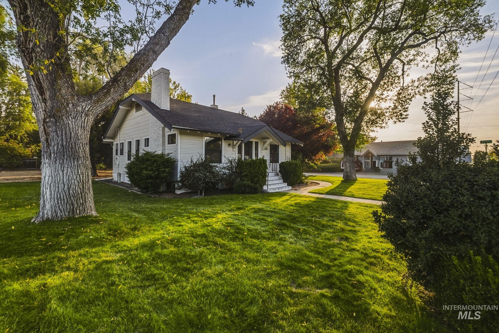 3113 West Overland Road Boise, ID 83705 - Photo 4 of 40 Residential property with mature trees and a manicured lawn
