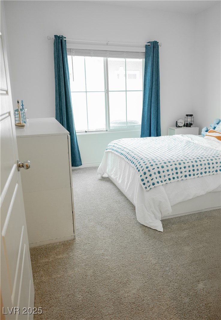 7342 North Decatur Boulevard, Unit 5 North Las Vegas, NV 89084 - Photo 12 of 29 Bedroom featuring carpet floors