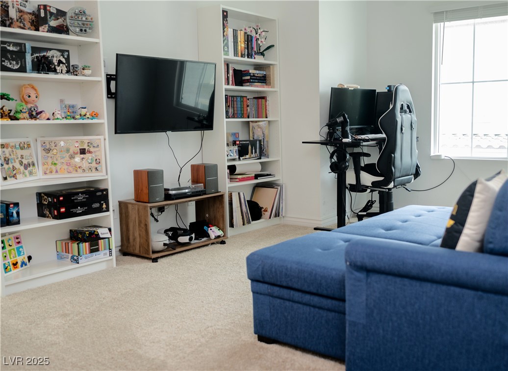 7342 North Decatur Boulevard, Unit 5 North Las Vegas, NV 89084 - Photo 15 of 29 Carpeted living area featuring healthy amount of natural light