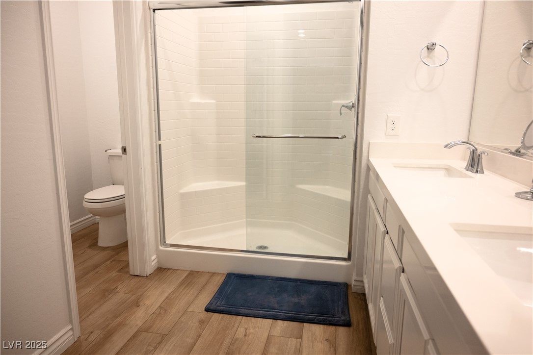 7342 North Decatur Boulevard, Unit 5 North Las Vegas, NV 89084 - Photo 18 of 29 Full bath with wood finished floors, toilet, a shower stall, and double vanity