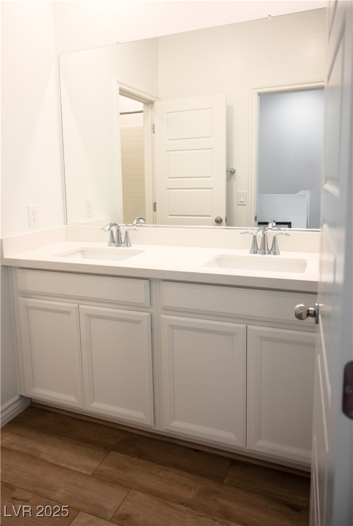 7342 North Decatur Boulevard, Unit 5 North Las Vegas, NV 89084 - Photo 22 of 29 Bathroom featuring double vanity and wood finished floors