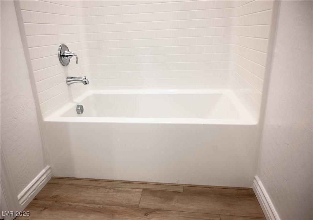 7342 North Decatur Boulevard, Unit 5 North Las Vegas, NV 89084 - Photo 23 of 29 Bathroom featuring wood finished floors and a textured wall