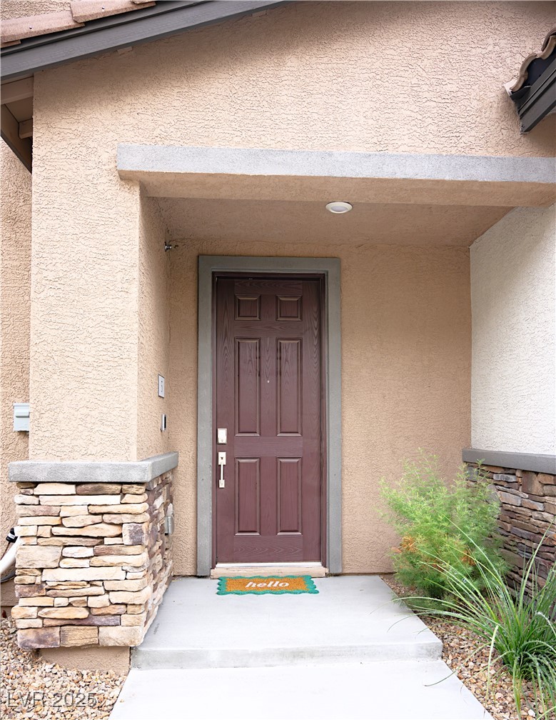 7342 North Decatur Boulevard, Unit 5 North Las Vegas, NV 89084 - Photo 4 of 29 Entrance to property with stucco siding and stone siding