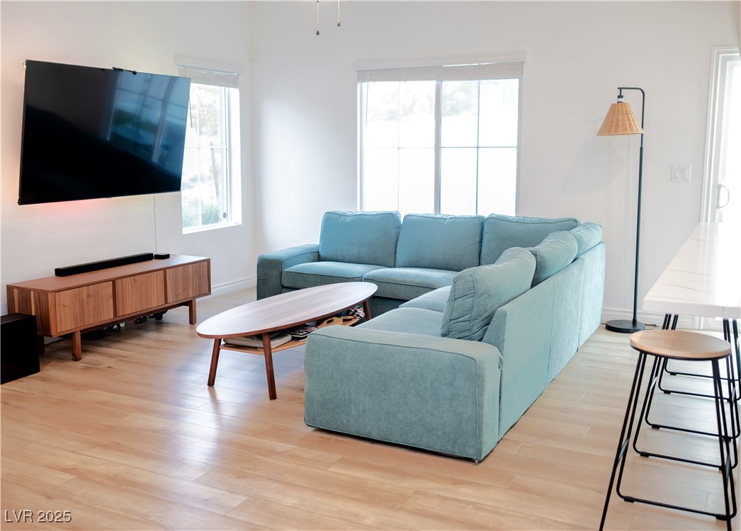 7342 North Decatur Boulevard, Unit 5 North Las Vegas, NV 89084 - Photo 5 of 29 Living area with light wood-style flooring and baseboards