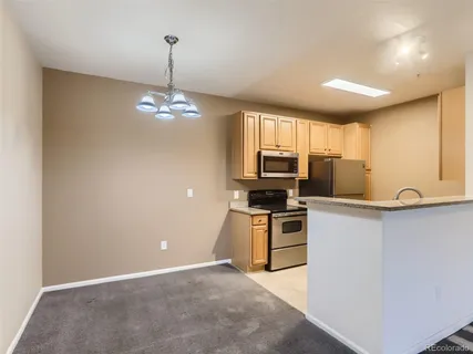 a kitchen with stove a microwave and refrigerator