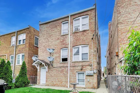 front view of a brick house with a large windows