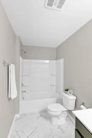 a bathroom with a toilet sink and shower