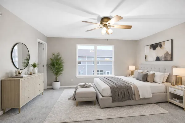 a bedroom with a large bed and a chandelier