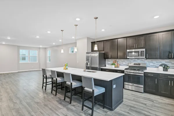a large kitchen with a table and chairs