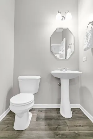a bathroom with a toilet and a mirror