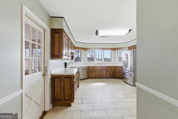 a kitchen with a refrigerator and microwave