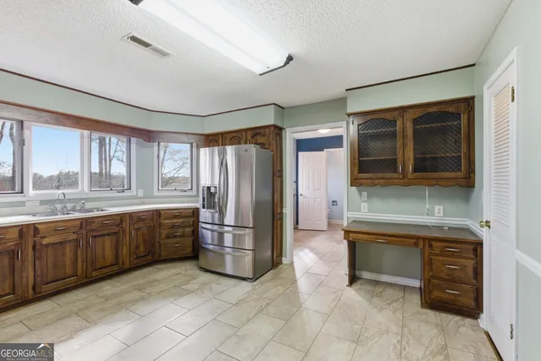 a sink with a window and cabinets