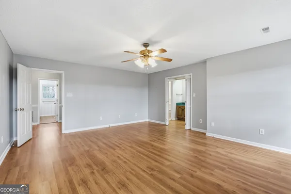 a view of a room with wooden floor and closet