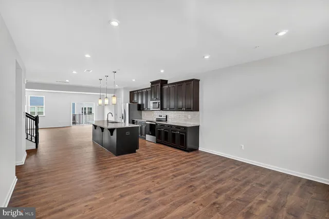 a kitchen with stainless steel appliances kitchen island wooden cabinets and granite counter tops