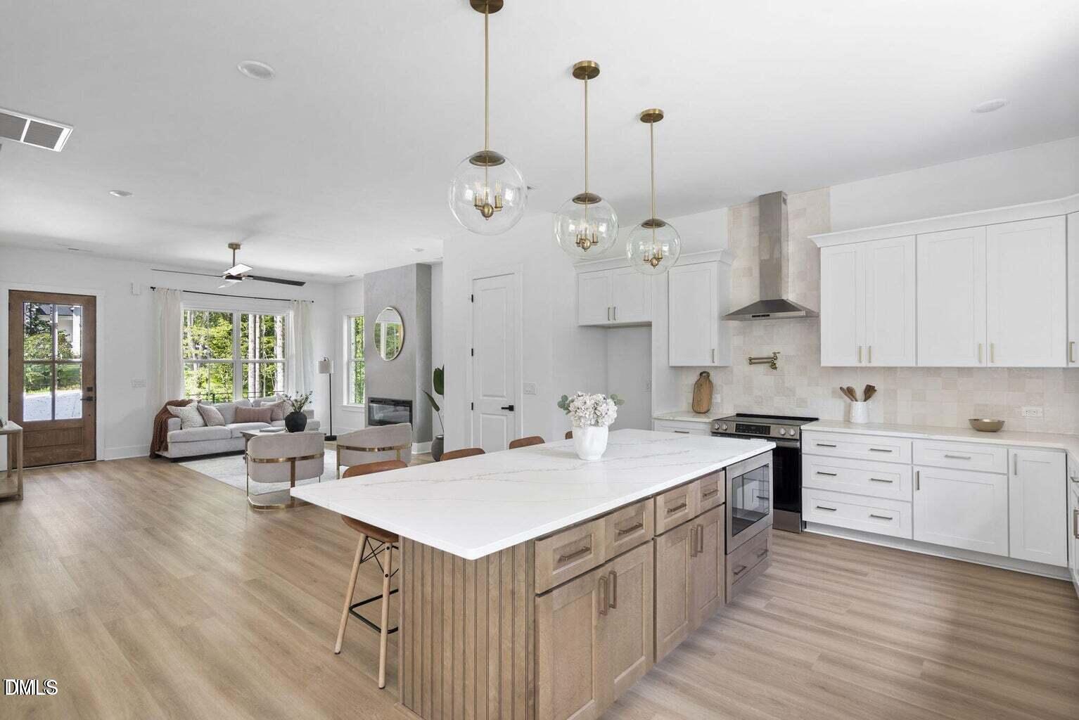 712 Oaks Lane Road Timberlake, NC 27583 - Photo 11 of 49 a kitchen that has a lot of cabinets a sink and wooden floor