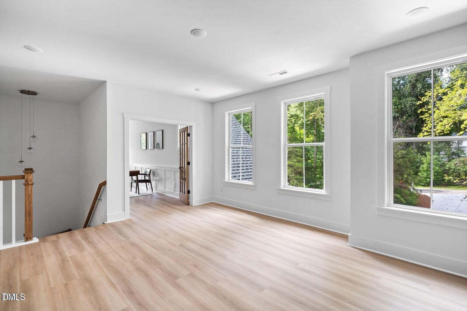 712 Oaks Lane Road Timberlake, NC 27583 - Photo 22 of 49 a view of an empty room with wooden floor and a window
