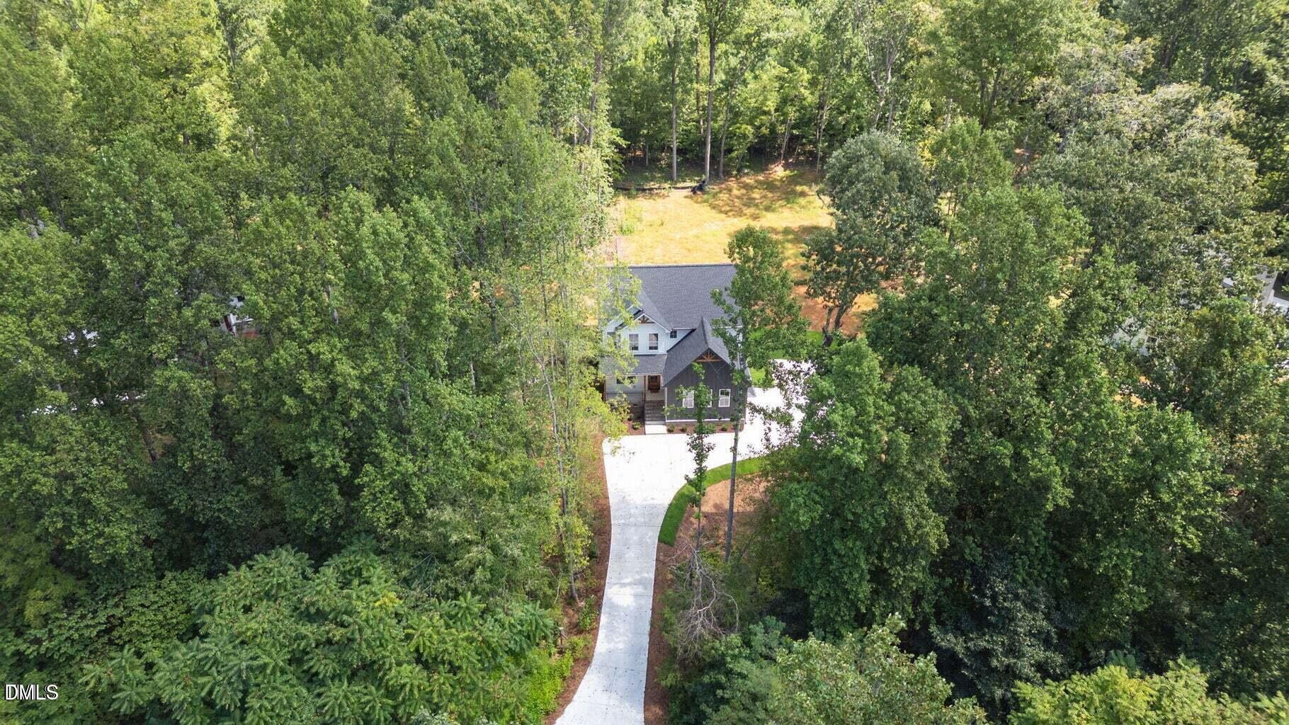 712 Oaks Lane Road Timberlake, NC 27583 - Photo 43 of 49 a view of a house with a yard