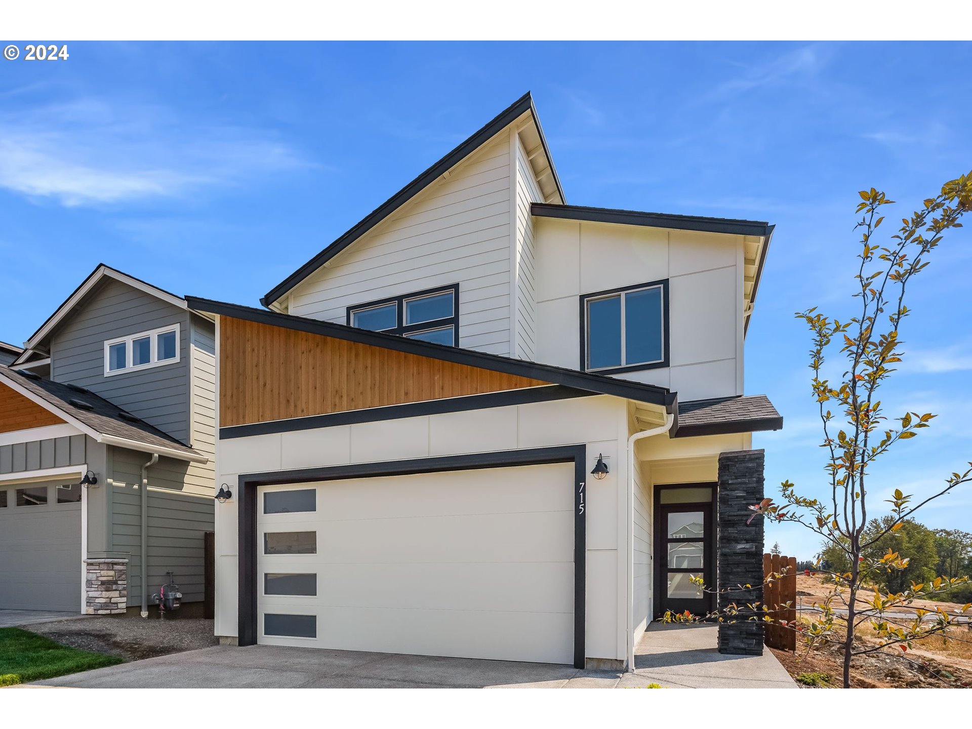 715 Northwest 174th Street Ridgefield, WA 98642 - Photo 1 of 20 a view of a house with a garage and potted plants