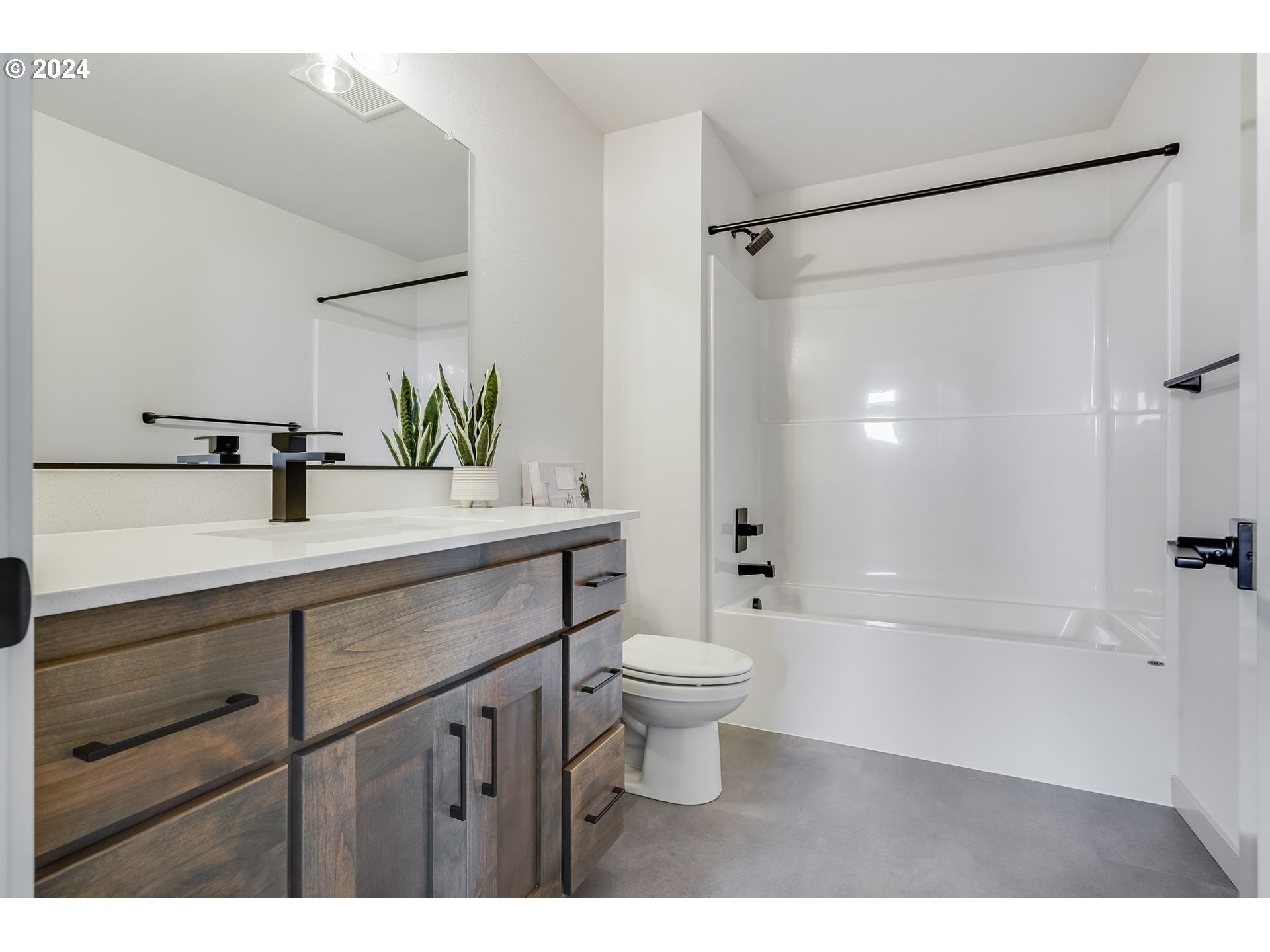 715 Northwest 174th Street Ridgefield, WA 98642 - Photo 11 of 20 a bathroom with a sink a toilet and shower
