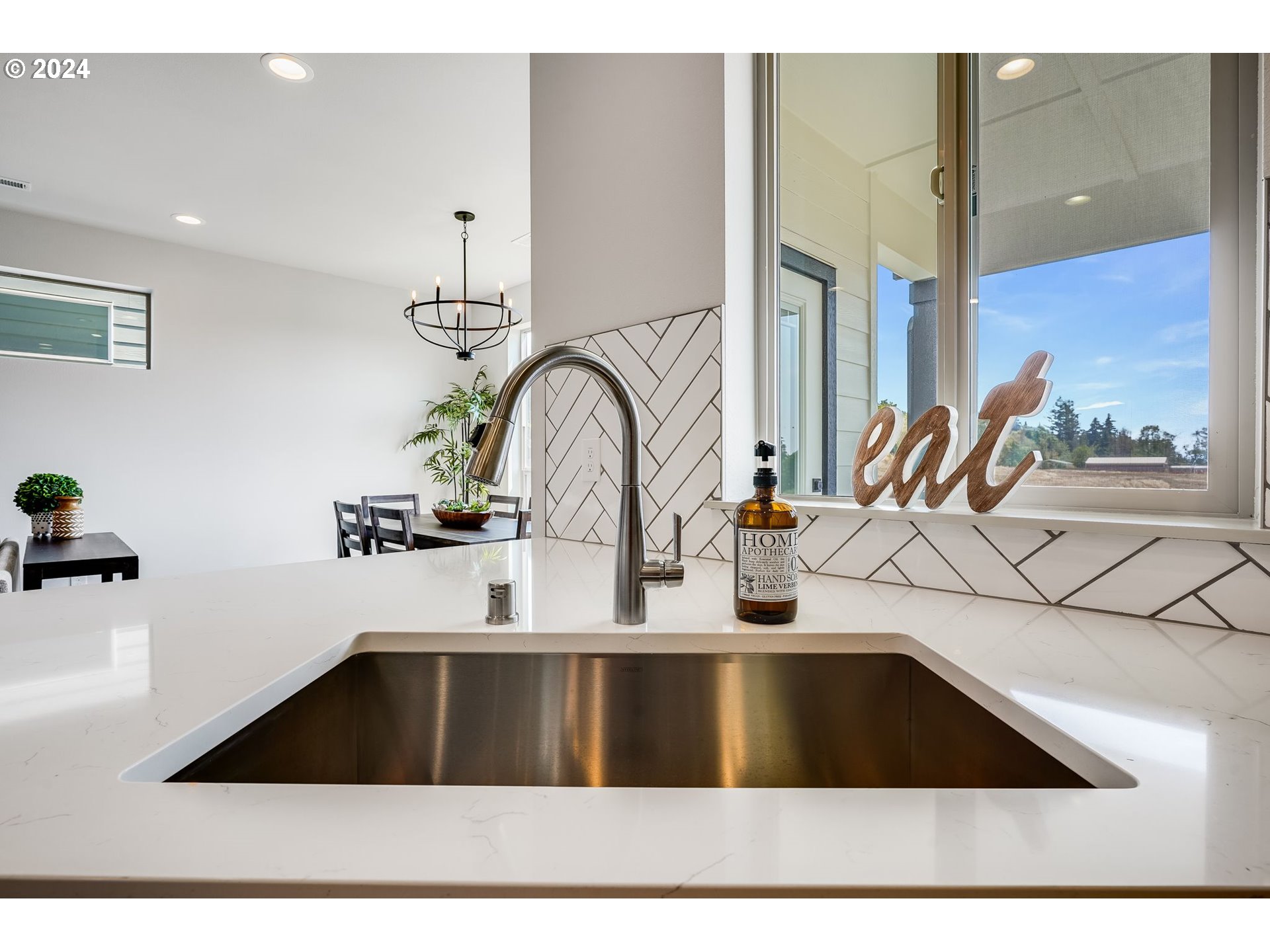 715 Northwest 174th Street Ridgefield, WA 98642 - Photo 3 of 20 a kitchen with a sink and a potted plant
